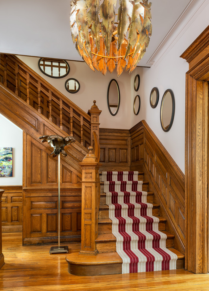 Small traditional wood l-shaped staircase in Toronto with wood risers and wood railing.