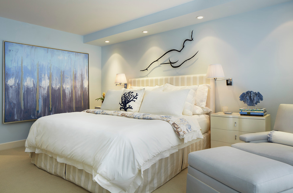 Transitional bedroom in Miami with blue walls and carpet.