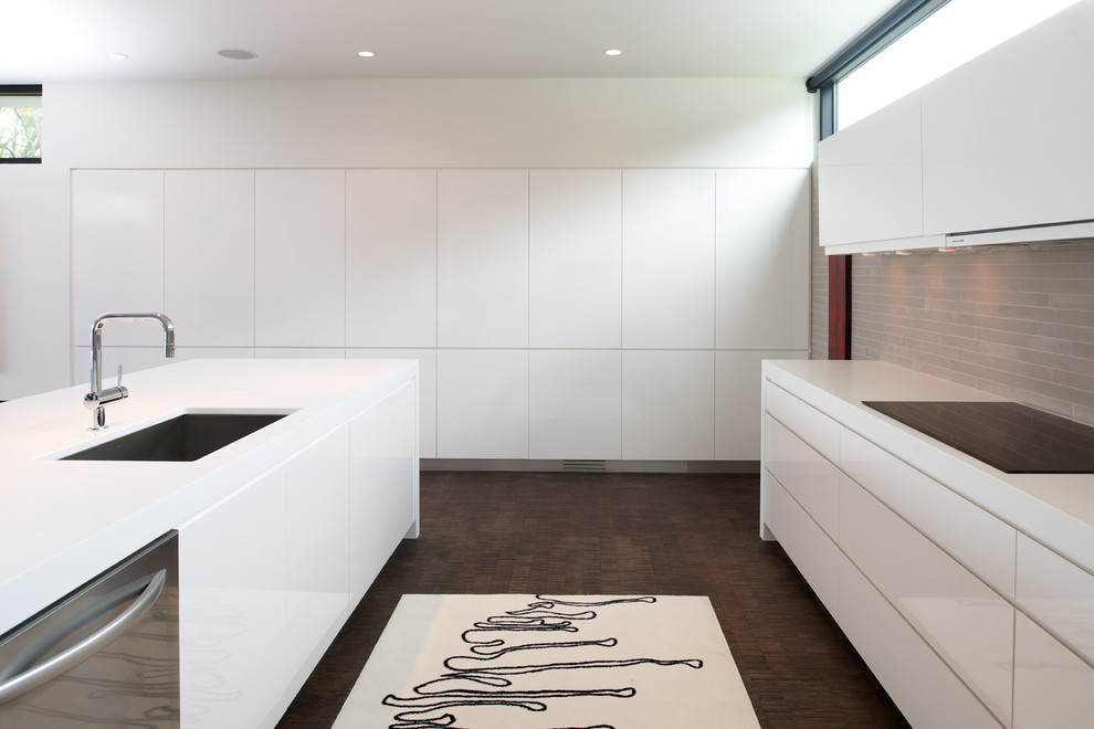Inspiration for a modern kitchen in Minneapolis with flat-panel cabinets and panelled appliances.