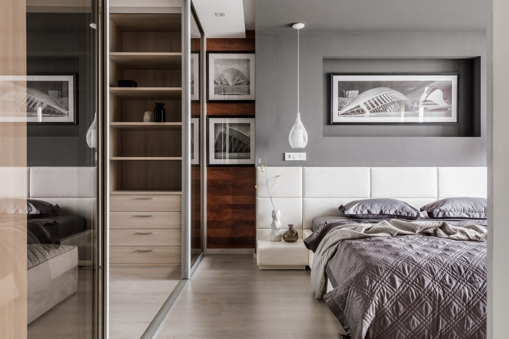 Photo of a mid-sized contemporary master bedroom in Other with grey walls, beige floor, wood walls and light hardwood floors.