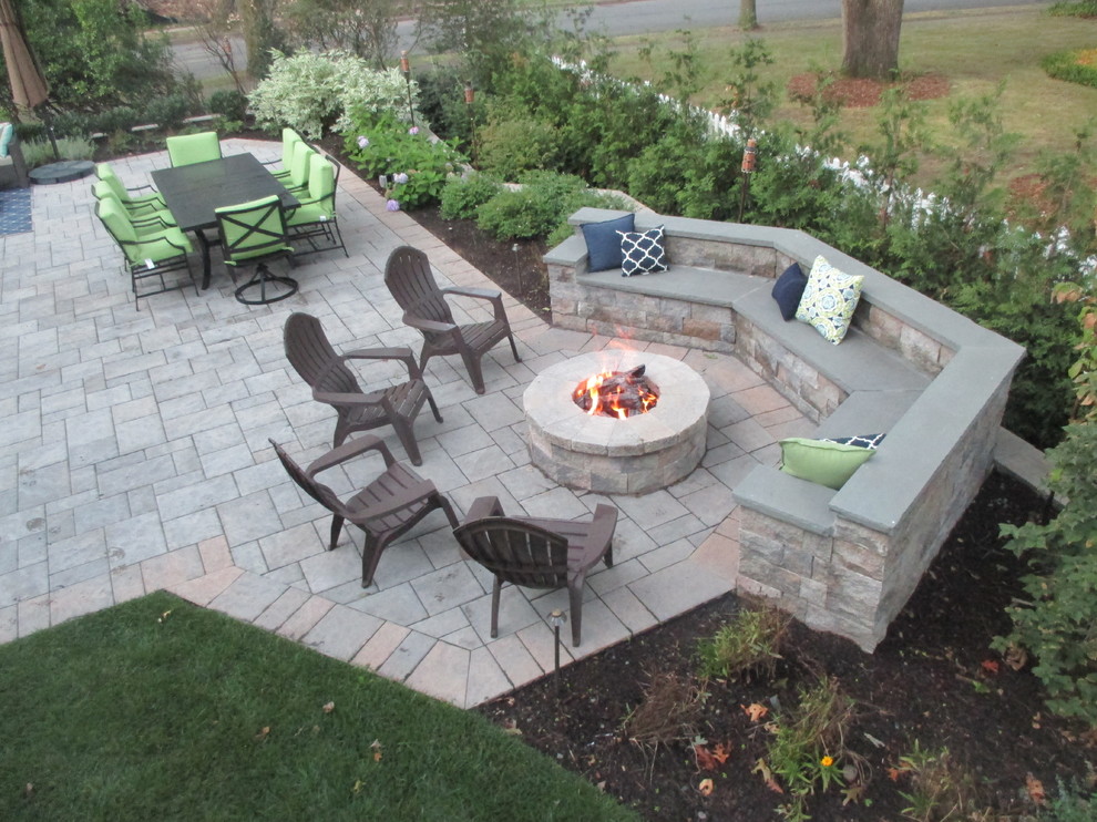 Large traditional backyard patio in New York with a fire feature, no cover and tile.