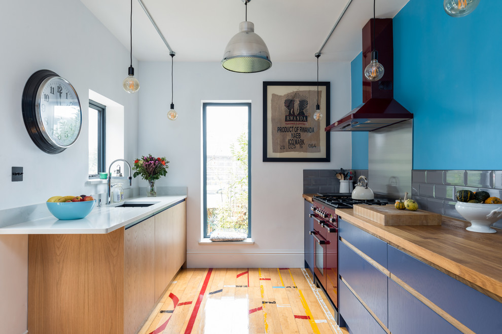 Small contemporary galley eat-in kitchen in Surrey with an integrated sink, flat-panel cabinets, medium wood cabinets, quartzite benchtops, grey splashback, coloured appliances, medium hardwood floors and multi-coloured floor.