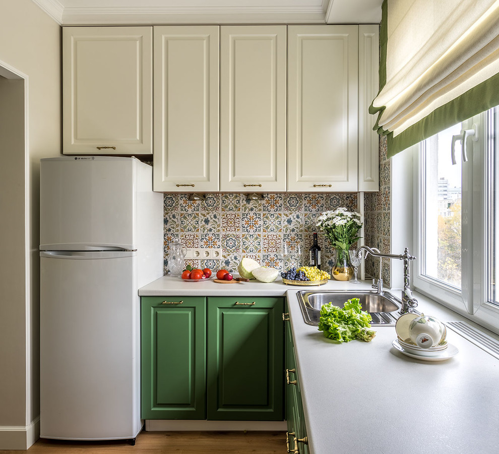 Inspiration for a small transitional l-shaped separate kitchen in Moscow with raised-panel cabinets, green cabinets, laminate benchtops, ceramic splashback, no island, a drop-in sink and multi-coloured splashback.
