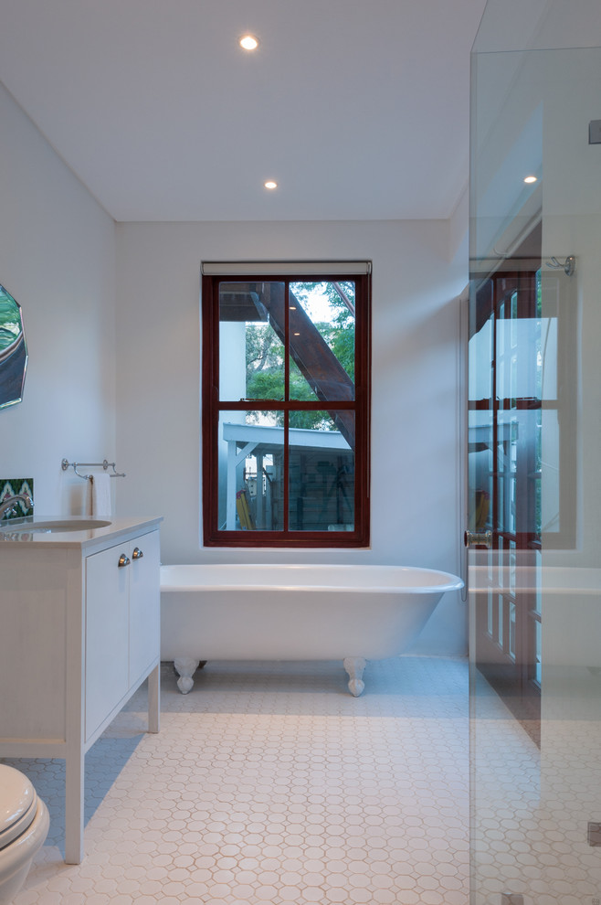 Photo of a traditional master bathroom in Other with flat-panel cabinets, white cabinets, a claw-foot tub, a corner shower, a two-piece toilet, white tile, ceramic tile, white walls, mosaic tile floors, an undermount sink and marble benchtops.