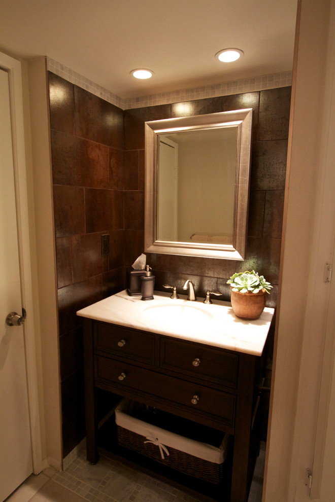 Bathroom - small transitional brown tile and porcelain tile marble floor bathroom idea in Phoenix with dark wood cabinets, quartzite countertops and brown walls