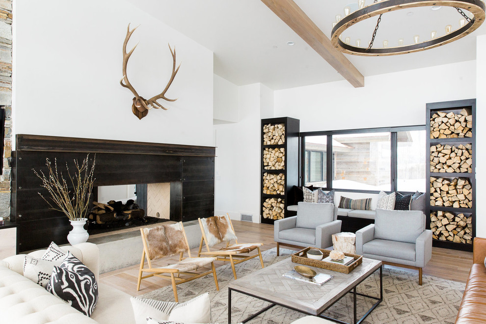 Design ideas for a transitional formal open concept living room in Salt Lake City with white walls, a two-sided fireplace and light hardwood floors.