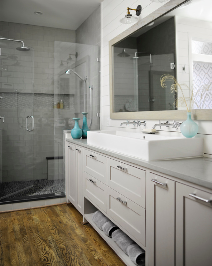 Design ideas for a small modern master bathroom in Nashville with shaker cabinets, grey cabinets, a freestanding tub, a double shower, a one-piece toilet, gray tile, ceramic tile, white walls, medium hardwood floors, a trough sink and solid surface benchtops.