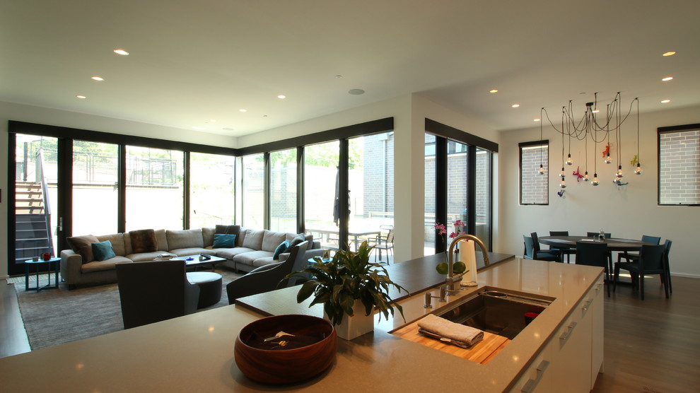 Photo of a mid-sized contemporary open concept family room in Chicago with white walls and medium hardwood floors.