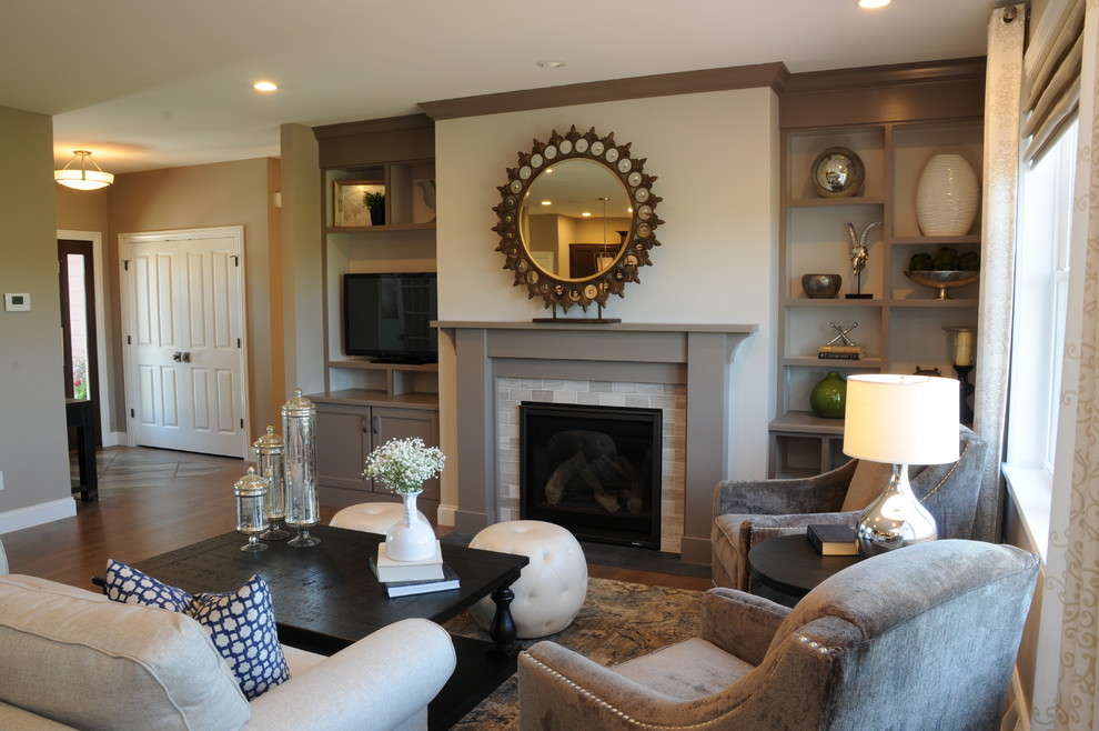 Photo of a large arts and crafts open concept family room in Other with light hardwood floors, a standard fireplace, a tile fireplace surround, a freestanding tv and grey walls.