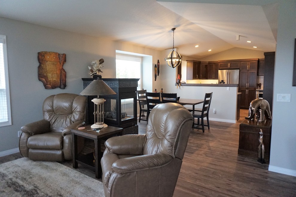 Example of a mid-sized transitional u-shaped dark wood floor and brown floor kitchen design in Calgary with a farmhouse sink, shaker cabinets, dark wood cabinets, granite countertops, white backsplash, subway tile backsplash, stainless steel appliances and a peninsula