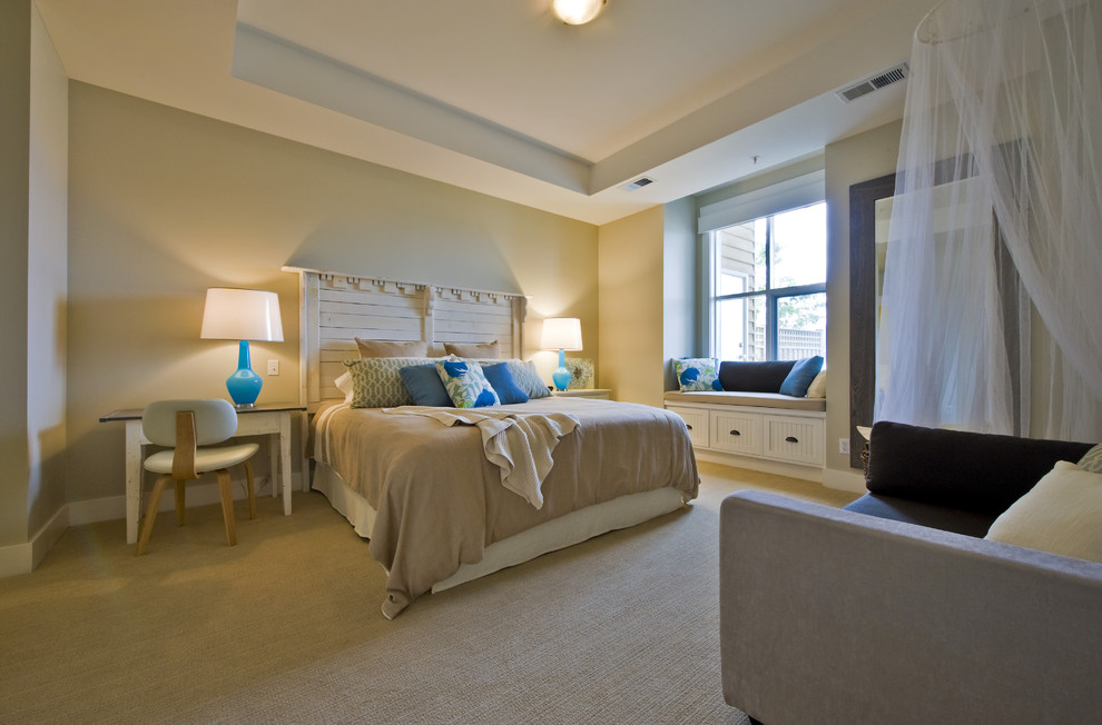This is an example of a beach style bedroom in Vancouver with beige walls and carpet.