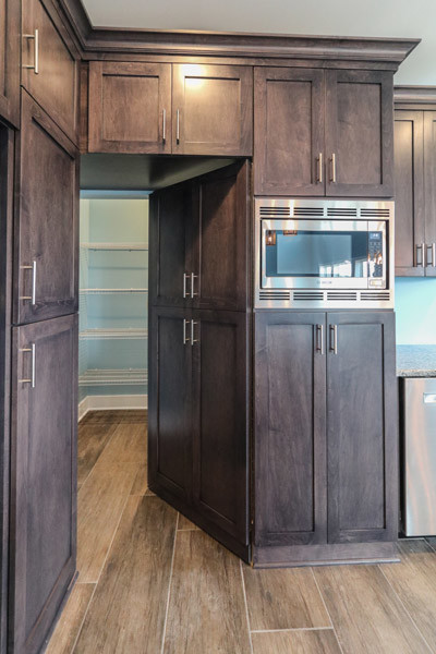 Photo of a mid-sized country u-shaped eat-in kitchen in Chicago with an undermount sink, granite benchtops, stainless steel appliances, ceramic floors, with island and grey floor.
