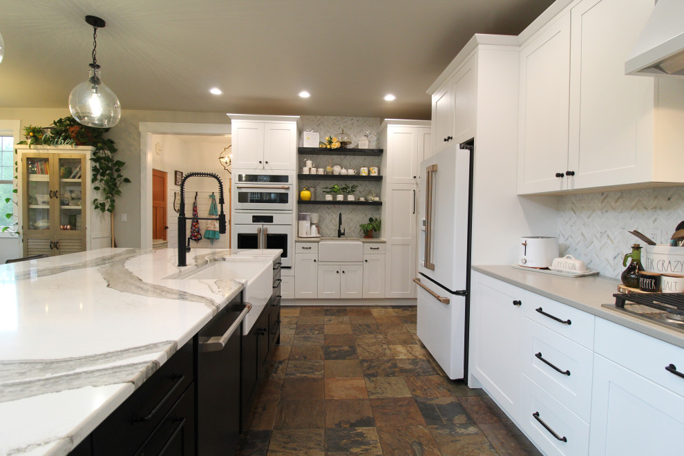Inspiration for a large country l-shaped open plan kitchen in Seattle with a farmhouse sink, recessed-panel cabinets, white cabinets, quartz benchtops, multi-coloured splashback, marble splashback, white appliances, slate floors, with island, multi-coloured floor and multi-coloured benchtop.