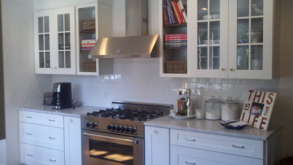 Small transitional kitchen photo in Other with glass-front cabinets, white cabinets, marble countertops, white backsplash, subway tile backsplash, stainless steel appliances, no island and gray countertops