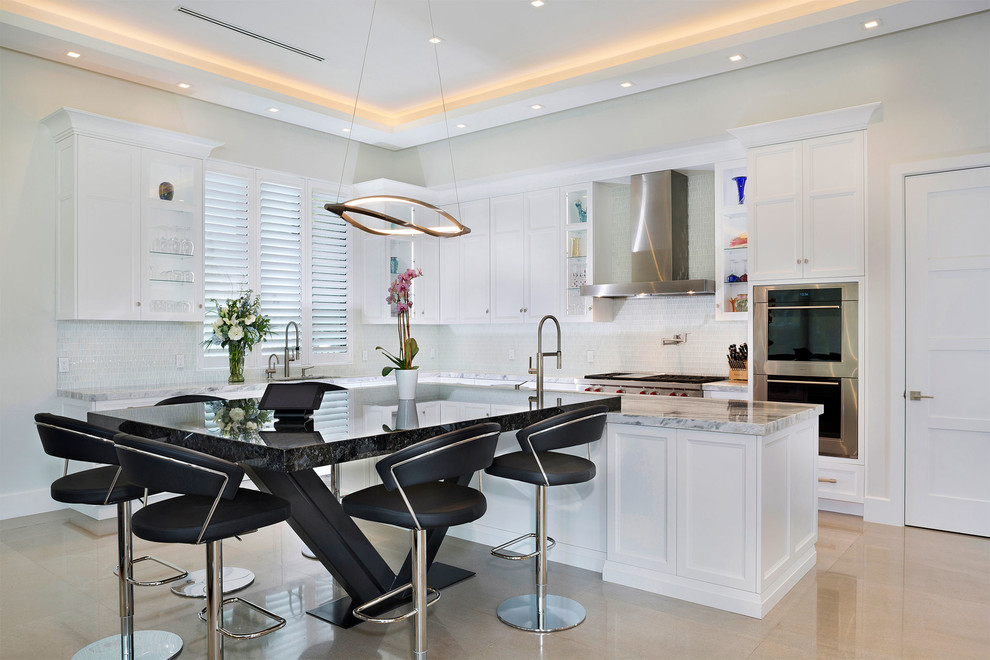 Mid-sized transitional l-shaped ceramic tile and beige floor open concept kitchen photo in Miami with an undermount sink, recessed-panel cabinets, white cabinets, marble countertops, multicolored backsplash, mosaic tile backsplash, stainless steel appliances, an island and multicolored countertops