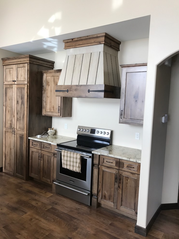 Inspiration for a large timeless dark wood floor and brown floor open concept kitchen remodel with flat-panel cabinets, distressed cabinets, granite countertops and an island