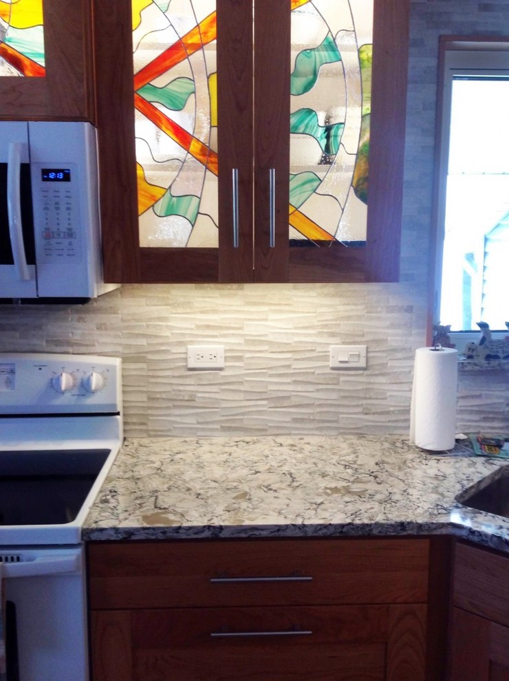 Example of a mid-sized transitional u-shaped medium tone wood floor enclosed kitchen design with an undermount sink, shaker cabinets, dark wood cabinets, granite countertops, gray backsplash, stone tile backsplash, white appliances and no island