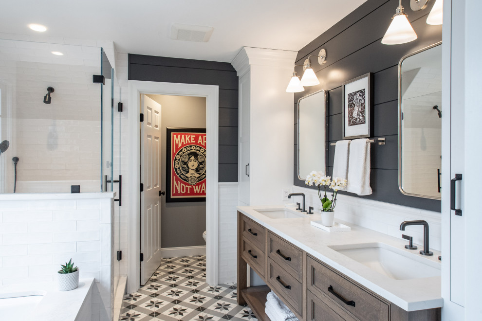 Photo of a large transitional master bathroom in Boston with recessed-panel cabinets, medium wood cabinets, an alcove shower, black walls, mosaic tile floors, an undermount sink, multi-coloured floor, a hinged shower door, white benchtops, a double vanity, a built-in vanity and planked wall panelling.