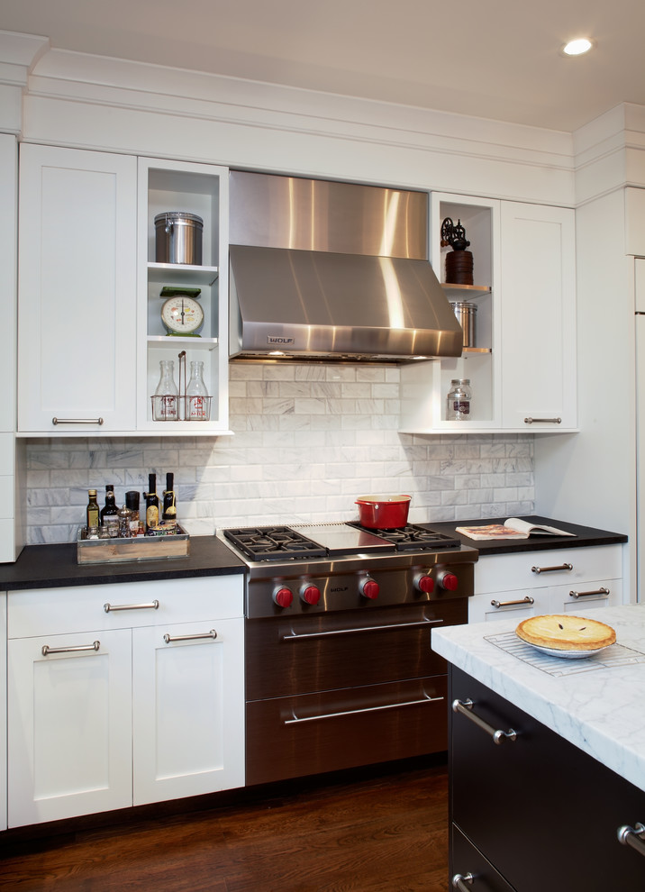 Inspiration for a large traditional l-shaped separate kitchen in Philadelphia with a farmhouse sink, shaker cabinets, white cabinets, marble benchtops, white splashback, subway tile splashback, panelled appliances, dark hardwood floors and with island.