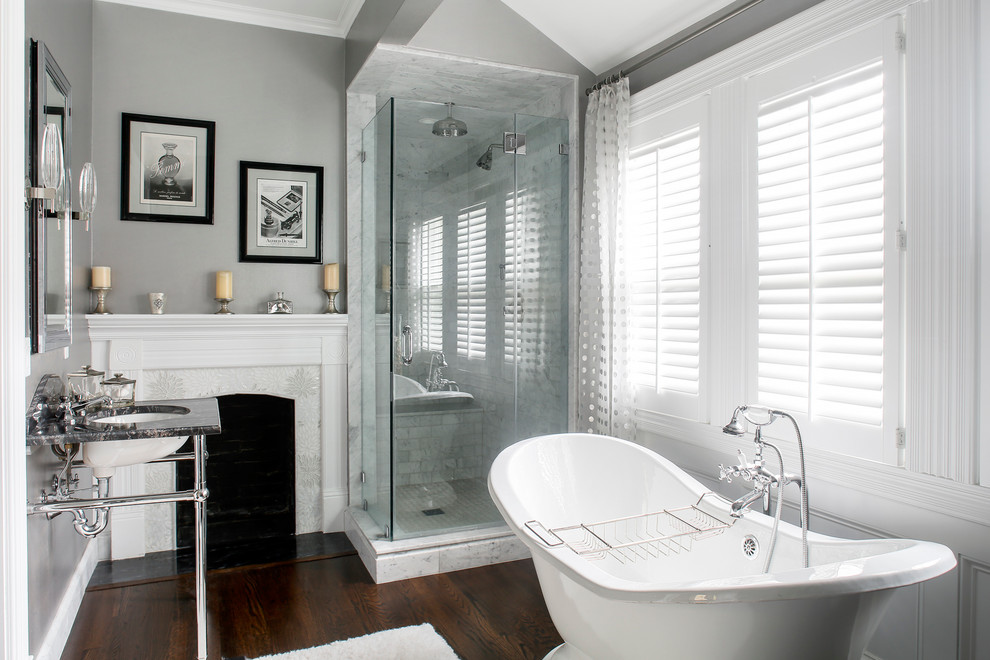 Traditional master bathroom in Boston with a freestanding tub, grey walls, dark hardwood floors, a console sink and a hinged shower door.