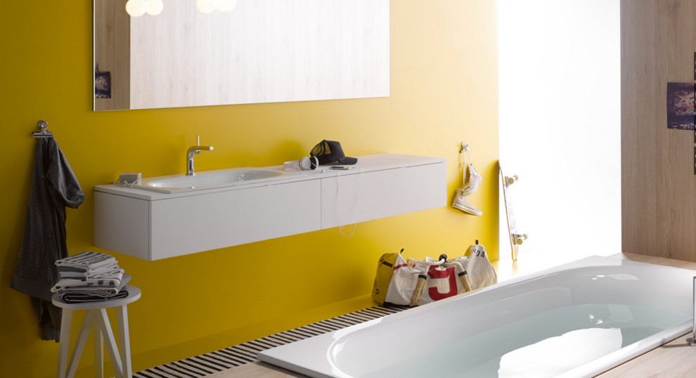 Photo of a large contemporary master bathroom in Other with a drop-in sink, white cabinets, a drop-in tub, yellow walls and flat-panel cabinets.