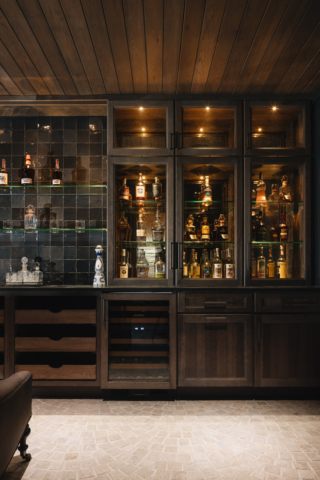 Bourbon & Wine Room - Bourbon and wine room featuring custom hickory cabinetry, antique mirror, black handmade tile backsplash, raised paneling, and Italian paver tile.