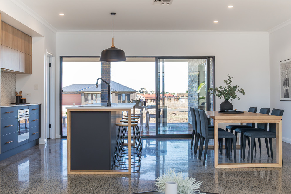 Inspiration for a scandinavian galley eat-in kitchen in Melbourne with an undermount sink, flat-panel cabinets, black cabinets, black appliances, with island and grey floor.