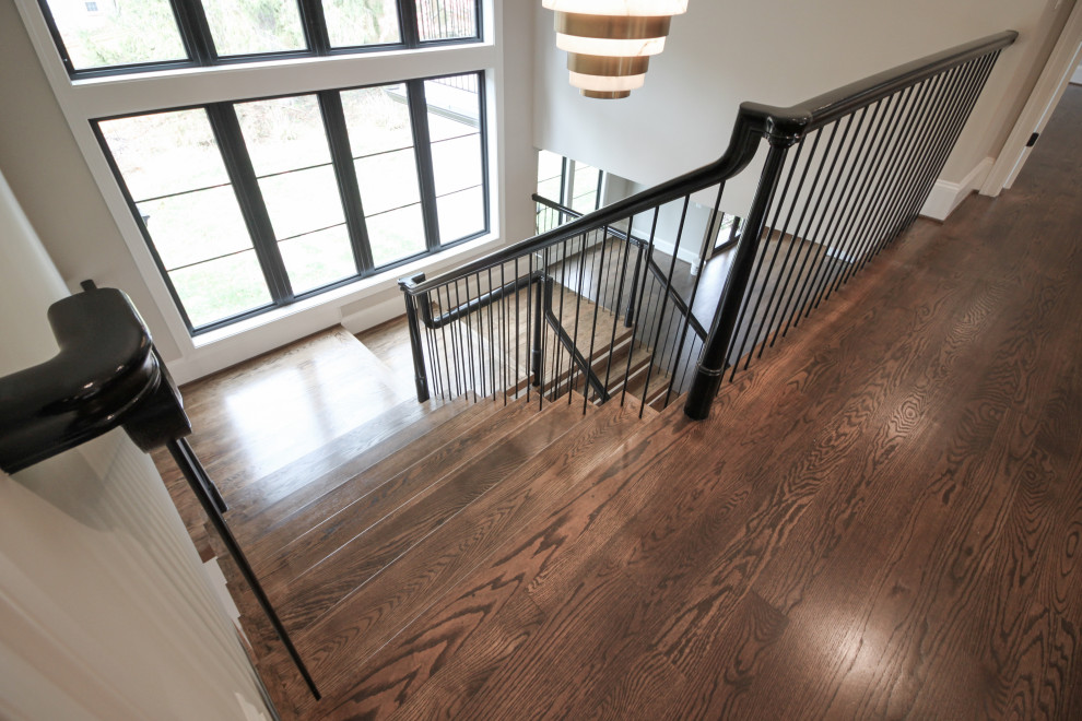 Design ideas for an expansive eclectic wood u-shaped staircase in DC Metro with wood risers and mixed railing.