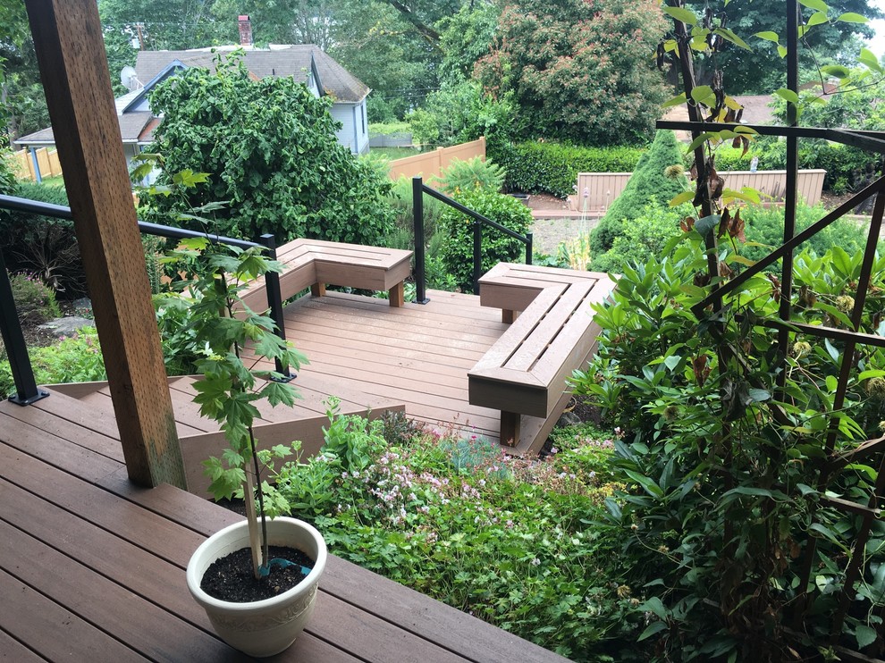 Design ideas for a mid-sized modern backyard deck in Seattle with no cover.