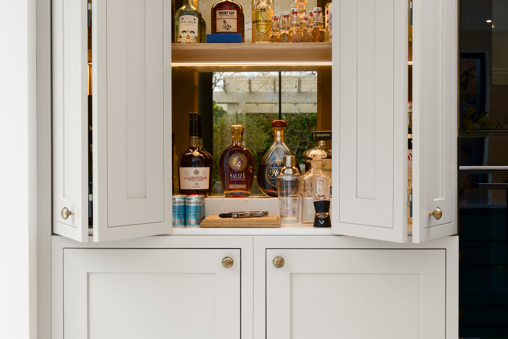 Design ideas for a large classic home bar in Surrey.