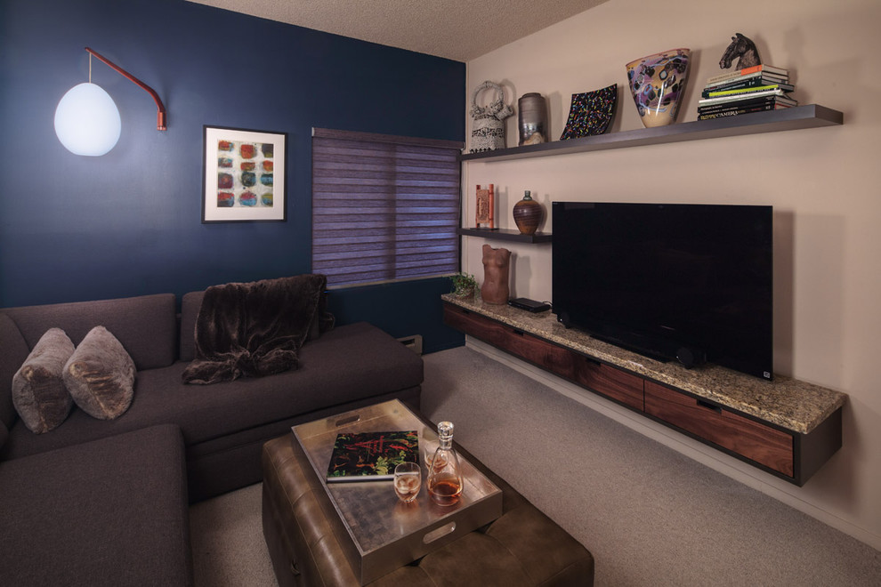 This is an example of a small contemporary enclosed home cinema in Portland with blue walls and carpet.