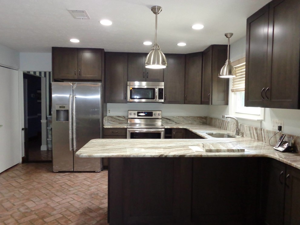 Inspiration for a small transitional u-shaped brick floor and red floor eat-in kitchen remodel in Baltimore with an undermount sink, shaker cabinets, granite countertops, brown backsplash, stone tile backsplash, stainless steel appliances, a peninsula and brown cabinets