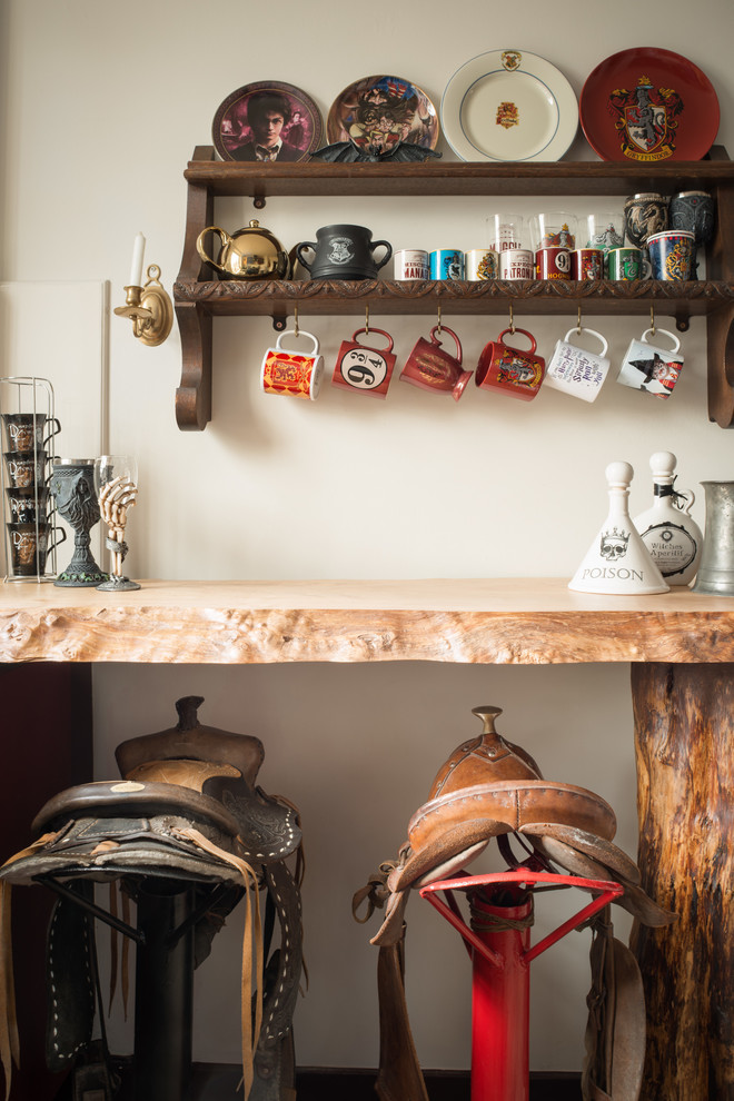 This is an example of an eclectic kitchen in London with wood benchtops.