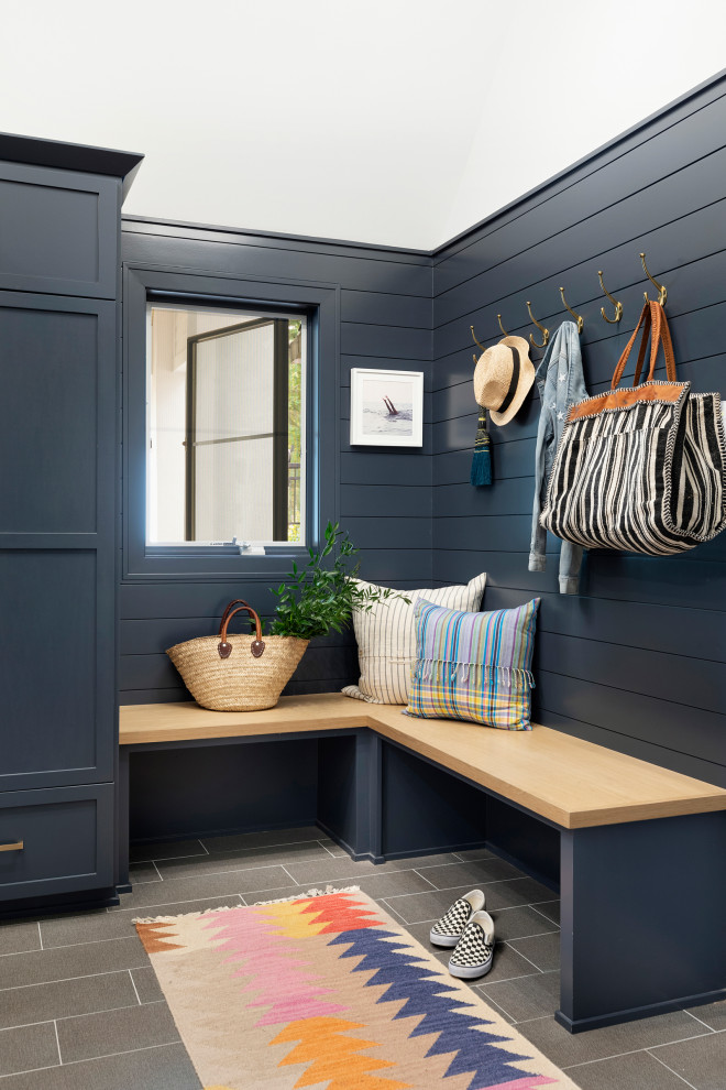 This is an example of a large beach style mudroom in Minneapolis with blue walls, ceramic floors, grey floor, vaulted and planked wall panelling.