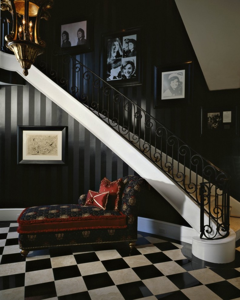This is an example of a mediterranean foyer in Phoenix with black walls and porcelain floors.