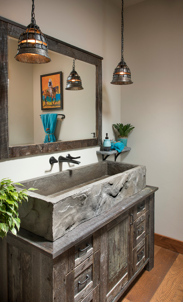 Mountain style medium tone wood floor bathroom photo with distressed cabinets, white walls, a trough sink and shaker cabinets