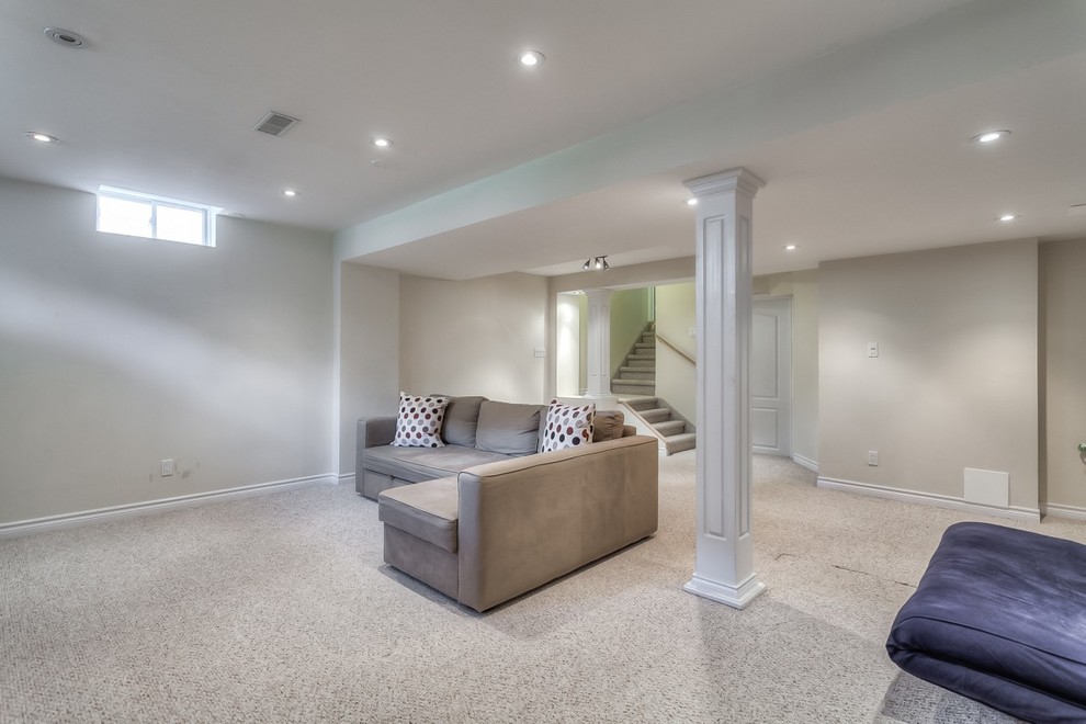 Basement - large transitional underground carpeted basement idea in Toronto with white walls