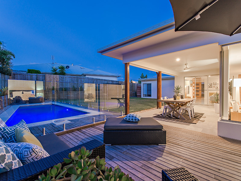 This is an example of a mid-sized scandinavian full sun formal garden in Sunshine Coast with decking.