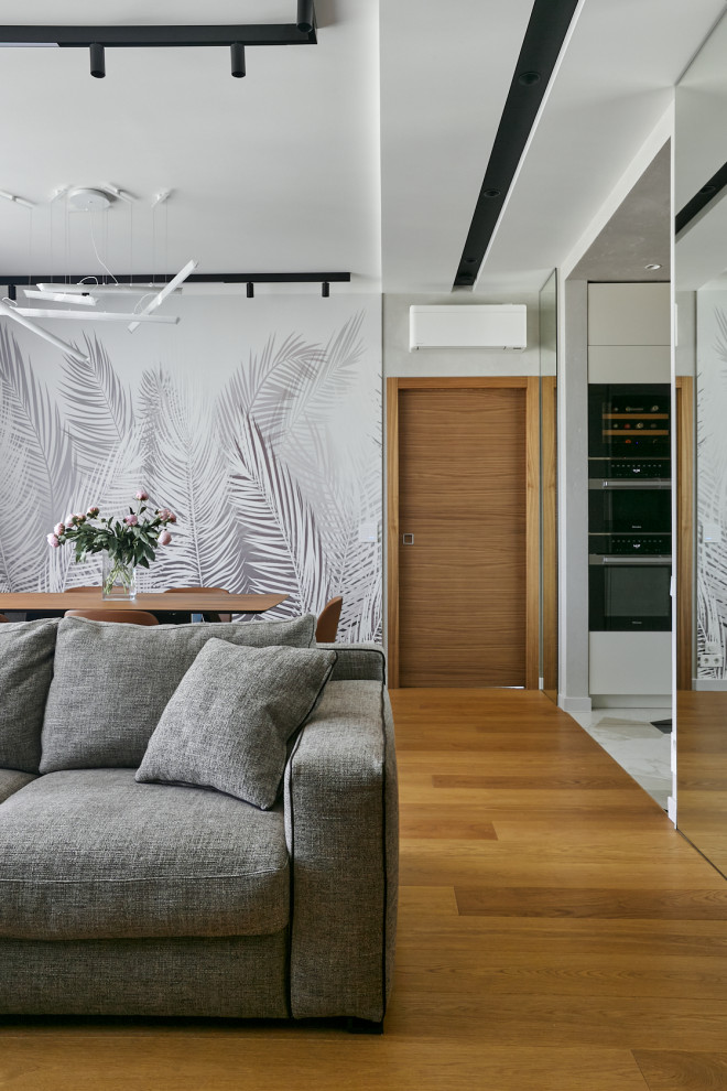 Идея дизайна: открытая гостиная комната в современном стиле с серыми стенами, паркетным полом среднего тона и многоуровневым потолком