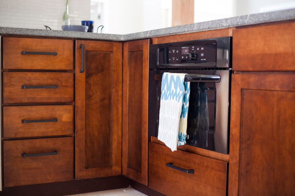 Example of a large transitional u-shaped eat-in kitchen design in Boston with an undermount sink, shaker cabinets, dark wood cabinets, granite countertops, gray backsplash, ceramic backsplash, stainless steel appliances and a peninsula