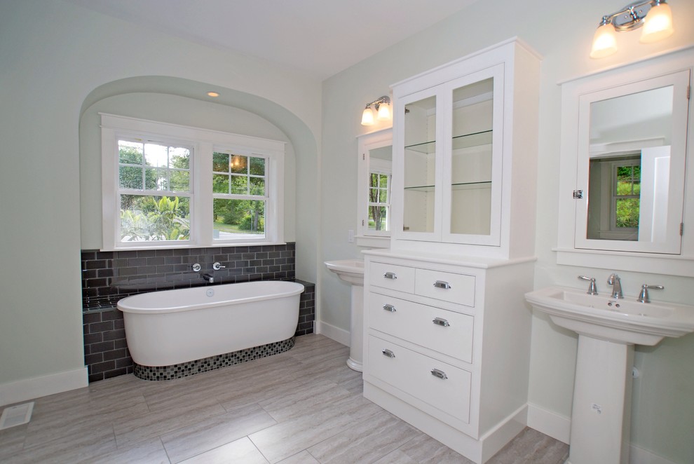 Photo of a mid-sized traditional master bathroom in Wilmington with furniture-like cabinets, white cabinets, wood benchtops, gray tile, porcelain tile, an alcove tub, a corner shower, a one-piece toilet, a pedestal sink, green walls and porcelain floors.