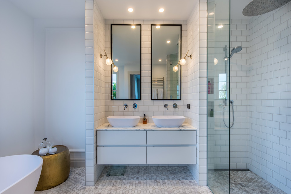 Design ideas for a large transitional bathroom in Auckland with flat-panel cabinets, white cabinets, a freestanding tub, an alcove shower, a one-piece toilet, white tile, subway tile, white walls, mosaic tile floors, a vessel sink, tile benchtops, grey floor and a hinged shower door.