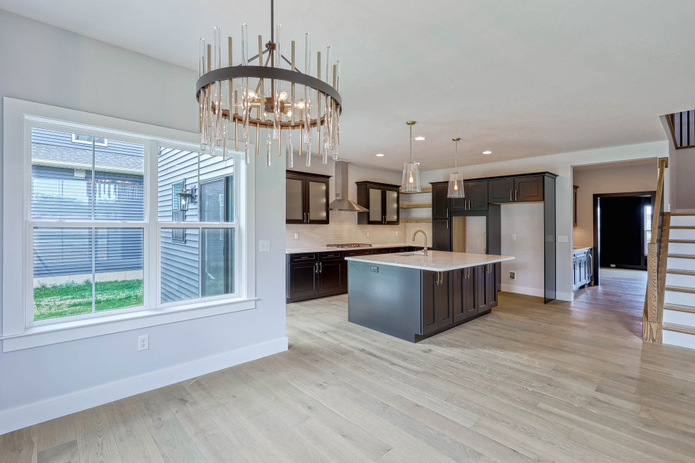 Photo of a large midcentury dining room in Other with grey walls, light hardwood floors and grey floor.