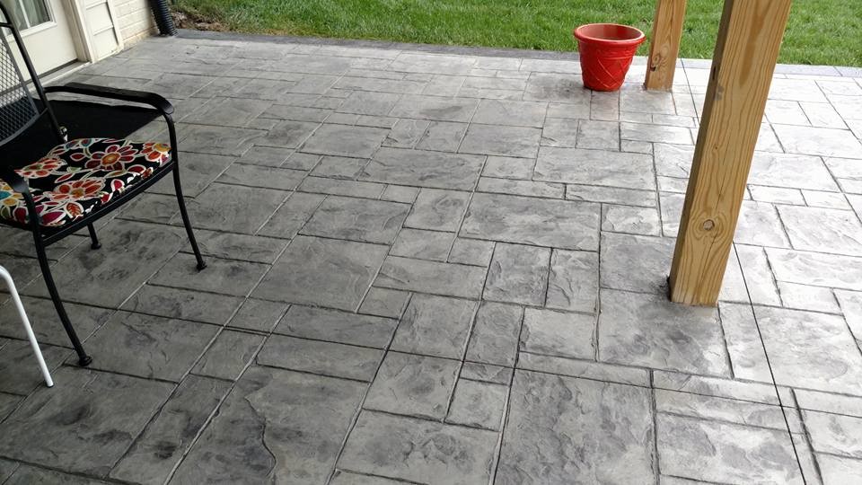 Photo of a mid-sized traditional backyard patio in Other with a fire feature, stamped concrete and no cover.