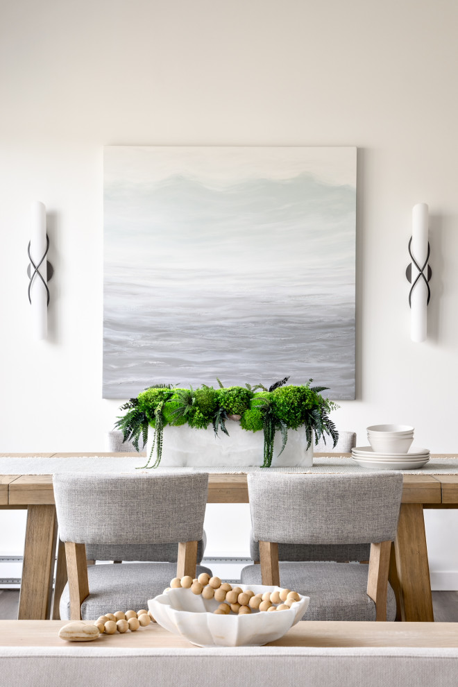Mid-sized beach style dining room in Vancouver with white walls and brown floor.