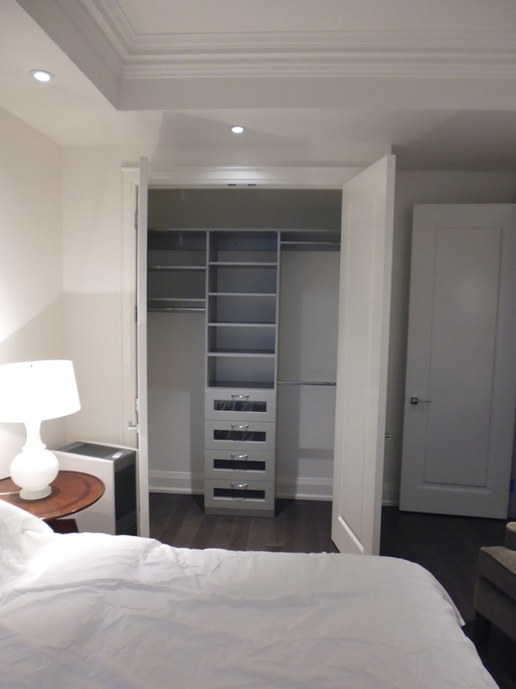 Design ideas for a small modern gender-neutral built-in wardrobe in Toronto with shaker cabinets and light wood cabinets.