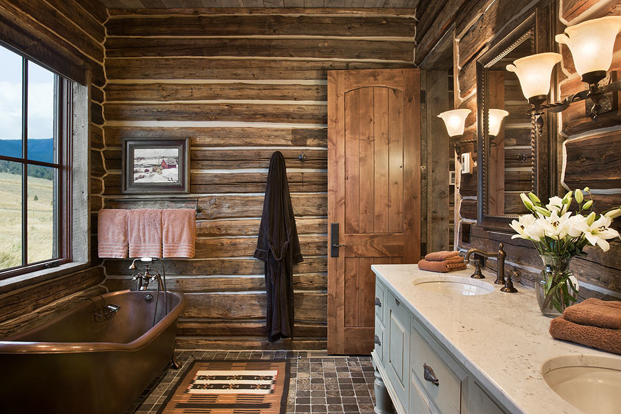 Claw-foot bathtub - large rustic master slate floor and multicolored floor claw-foot bathtub idea with furniture-like cabinets, an undermount sink, white cabinets, a two-piece toilet, brown walls, marble countertops and white countertops