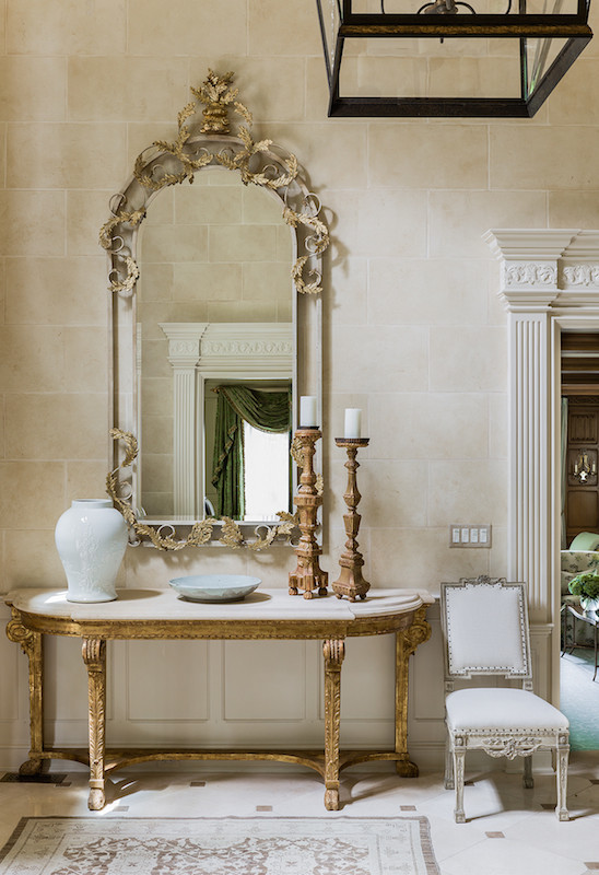 This is an example of an expansive traditional hallway in Boston with beige walls and travertine floors.