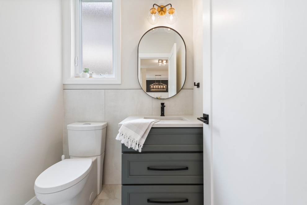 Photo of a small contemporary cloakroom in Ottawa with shaker cabinets, grey cabinets, a one-piece toilet, white tiles, ceramic tiles, white walls, ceramic flooring, a submerged sink, quartz worktops, white floors, white worktops and a freestanding vanity unit.