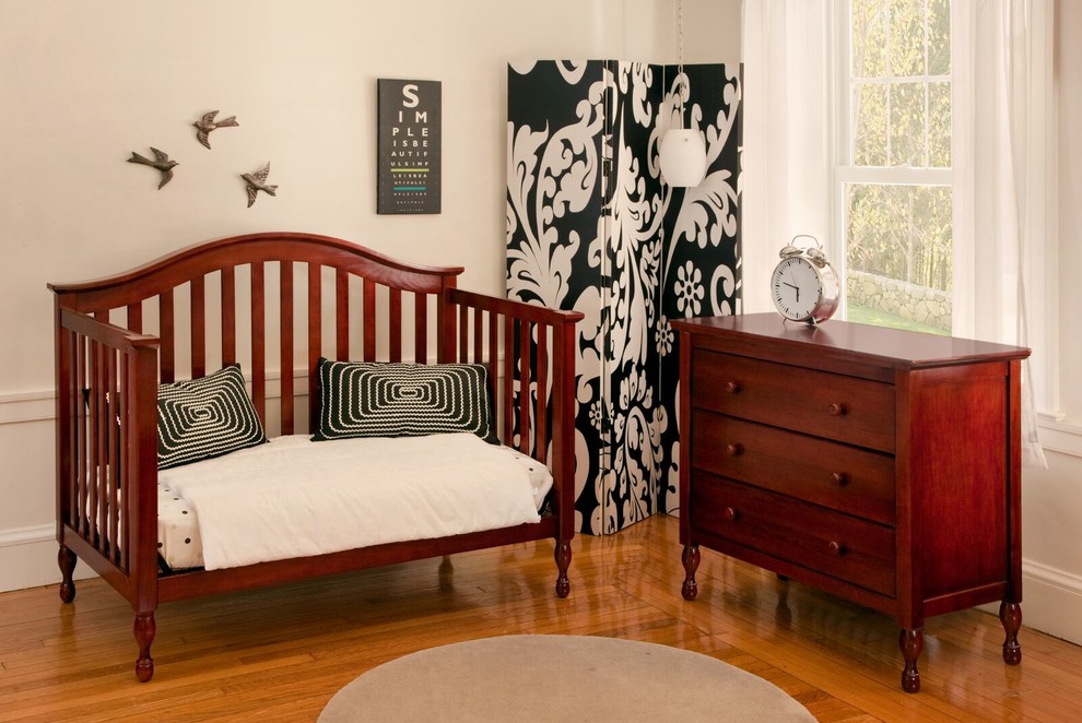 Photo of a mid-sized traditional gender-neutral nursery in Minneapolis with white walls and medium hardwood floors.